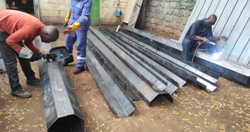 Flood light pole fabrication in workshop using structural steel